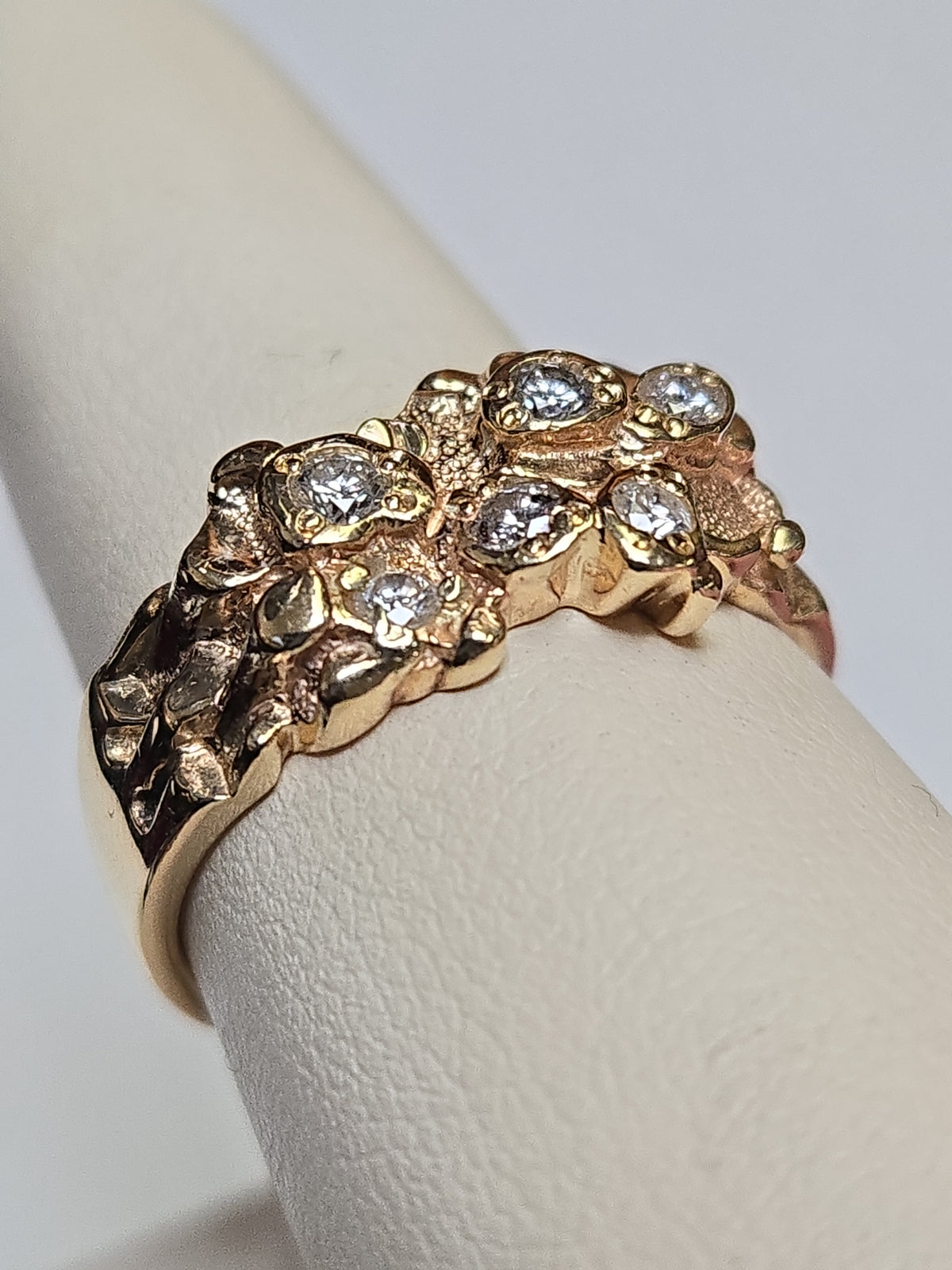 14K gold ring with 0.5ct round diamonds from Chique Jewelry, featuring a polished band and sparkling gemstone accents.