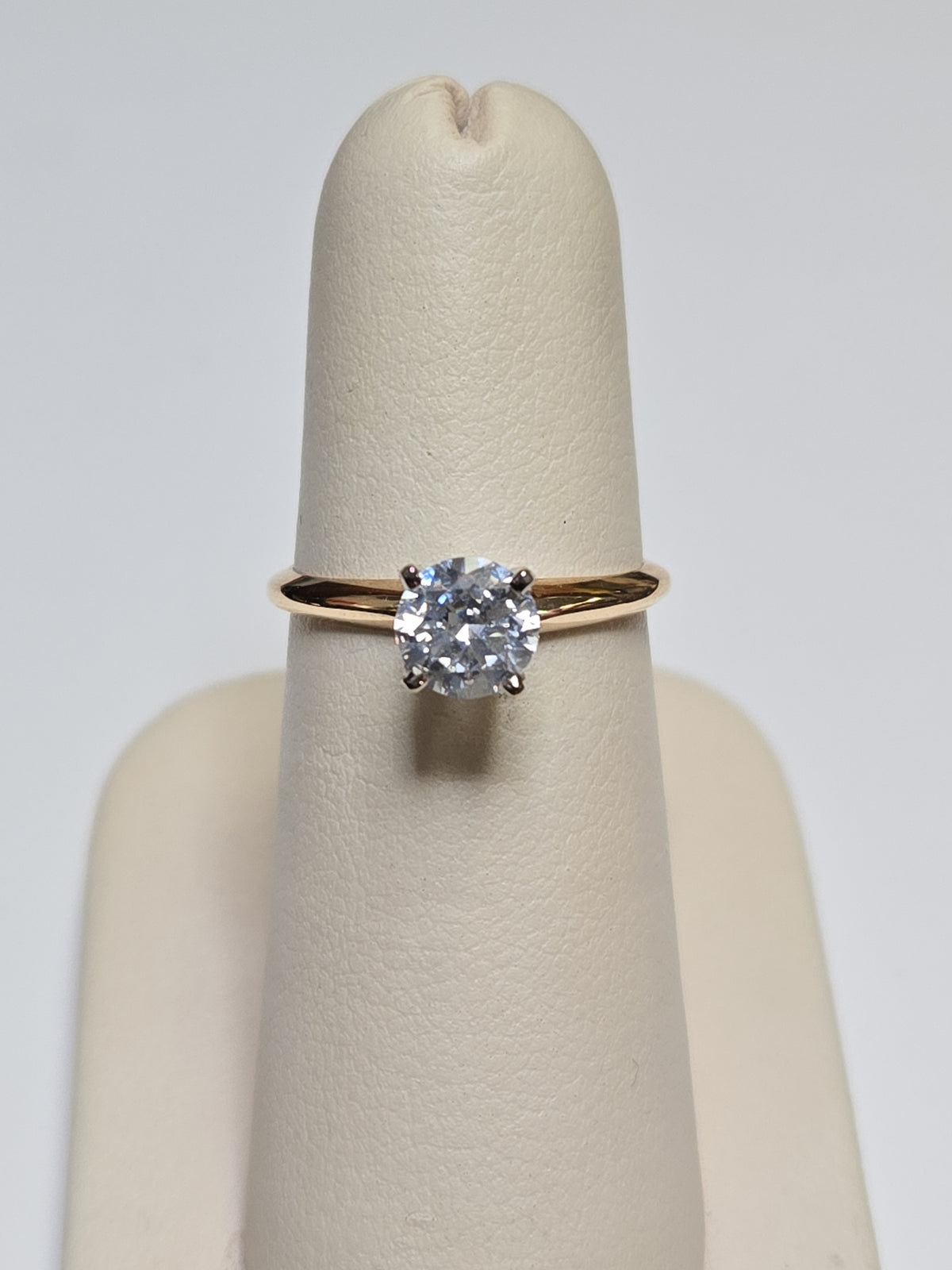 14K gold engagement ring with round cubic zirconia and 2.3g weight, showcasing a sparkling central stone and elegant band.