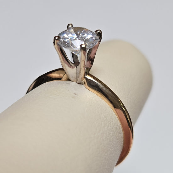 14K gold engagement ring with round cubic zirconia, featuring a sleek band and sparkling centerpiece by Chique Jewelry.