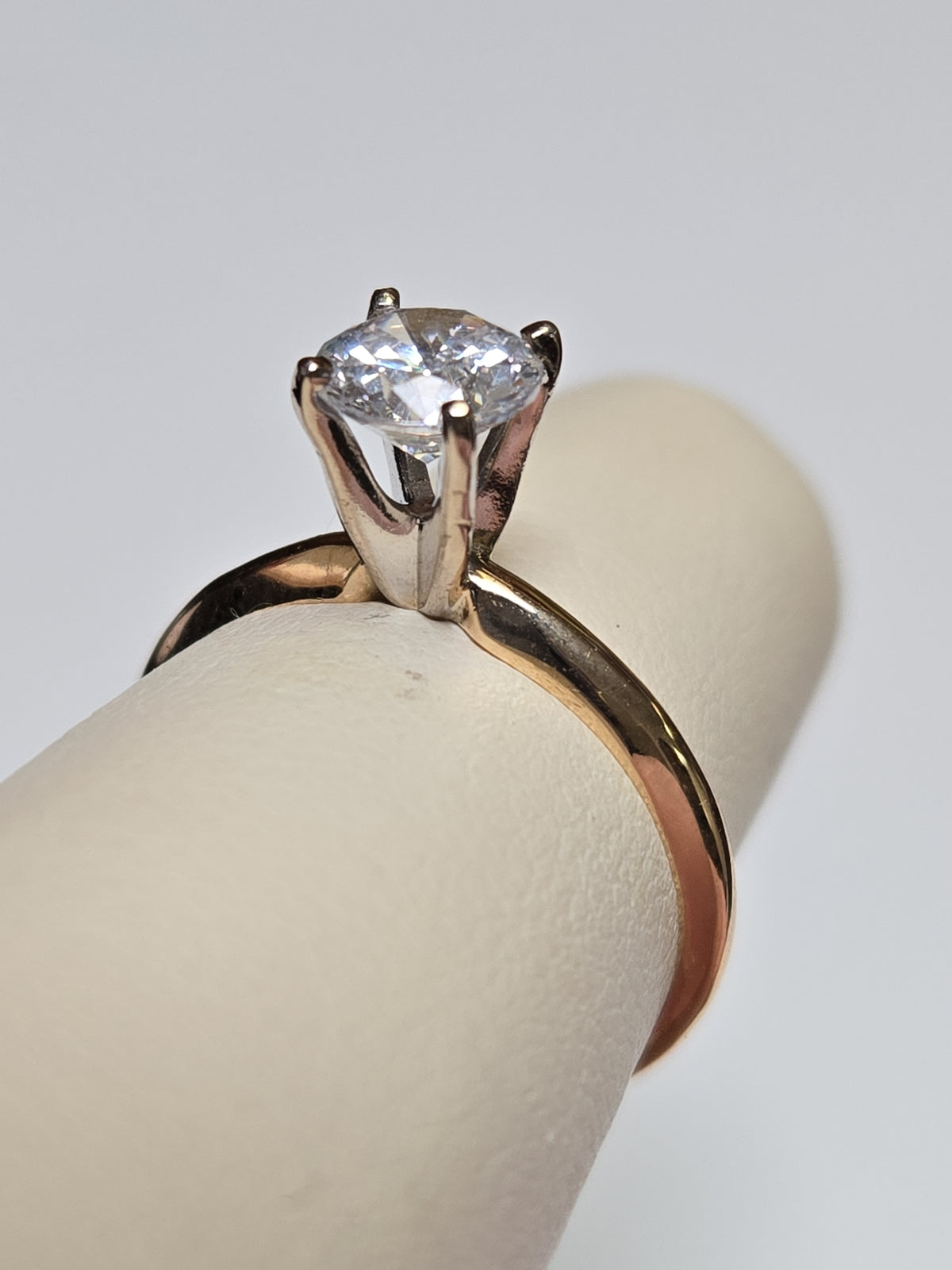 14K gold engagement ring with round cubic zirconia, featuring a sleek band and sparkling centerpiece by Chique Jewelry.