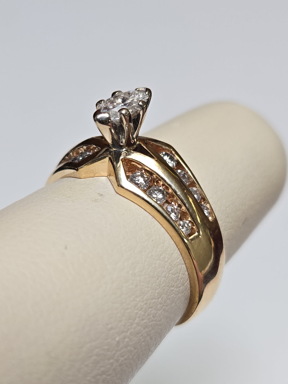 14K gold engagement ring with a 0.2ct marquise diamond, crafted by Chique Jewelry, featuring elegant design and fine craftsmanship.