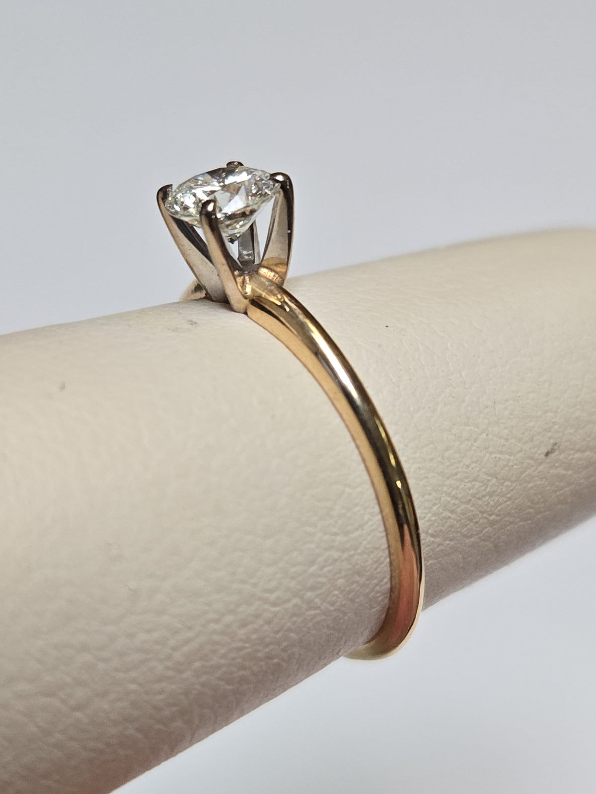 14K gold engagement ring with 0.44ct round diamond, delicate design by Chique Jewelry, featuring a sleek band and sparkling gemstone.