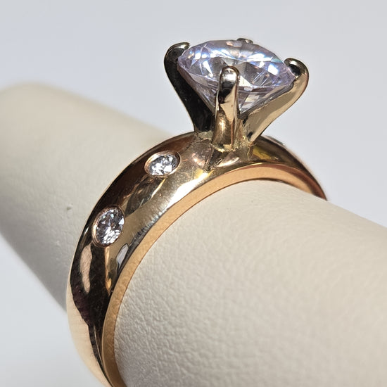 14K gold ring with round cubic zirconia stone, elegant jewelry piece from Chique Jewelry, showcasing its sparkling design.