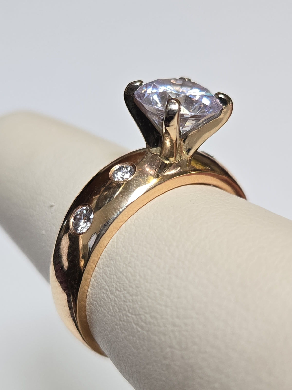 14K gold ring with round cubic zirconia stone, elegant jewelry piece from Chique Jewelry, showcasing its sparkling design.