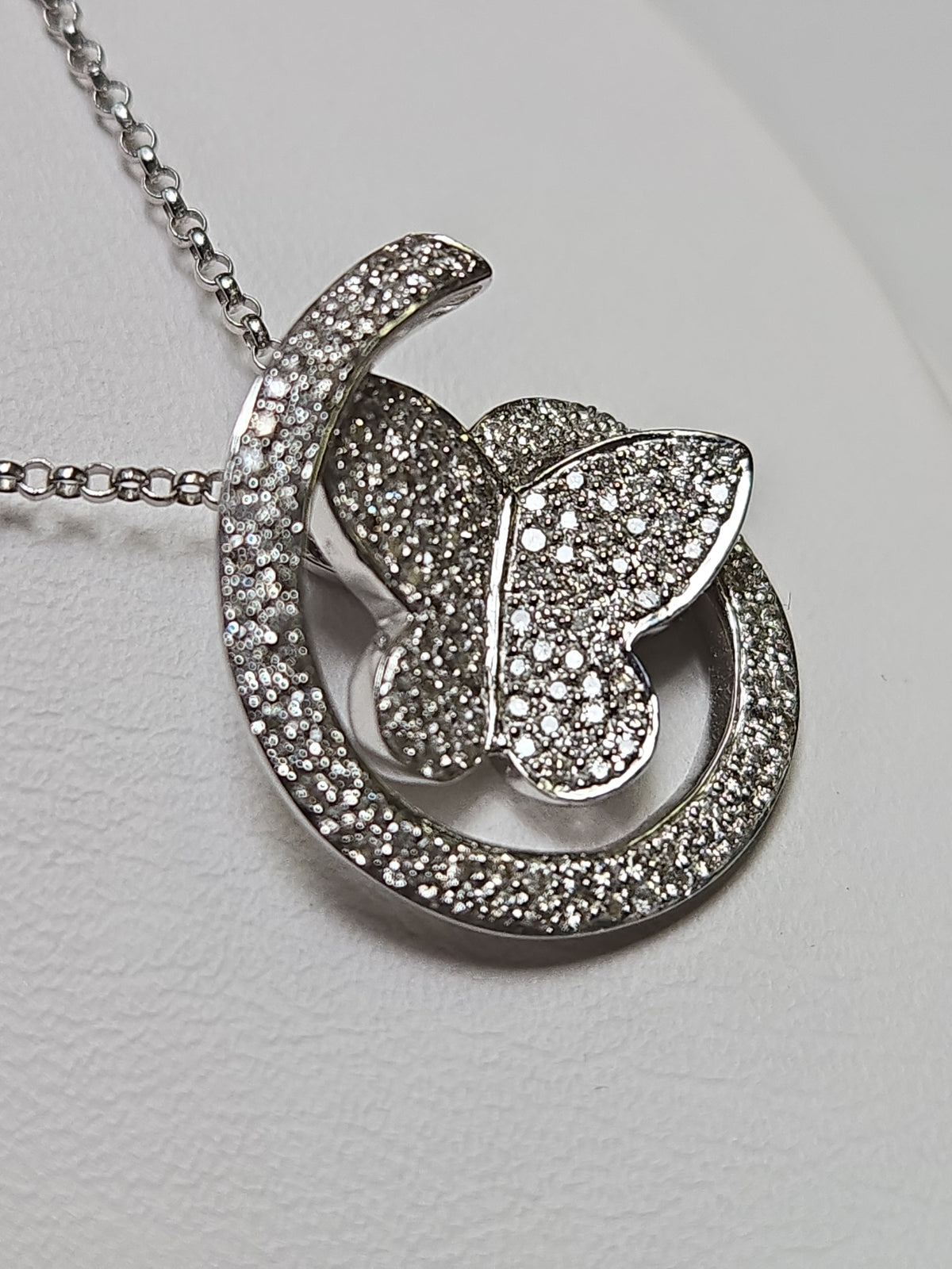 14K white gold rolo chain necklace with butterfly pendant featuring 0.41ct round diamonds from Chique Jewelry.