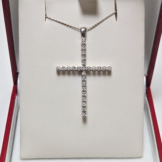 14K white gold cross pendant with 0.25ct lab-created round diamonds, weighing 1.6g, from Chique Jewelry.