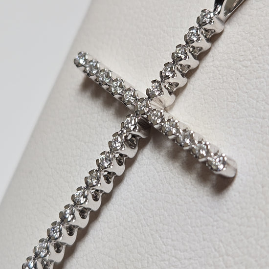 14K white gold cross pendant with 0.25ct lab-created diamonds, featuring a delicate design and weighing 1.6 grams.