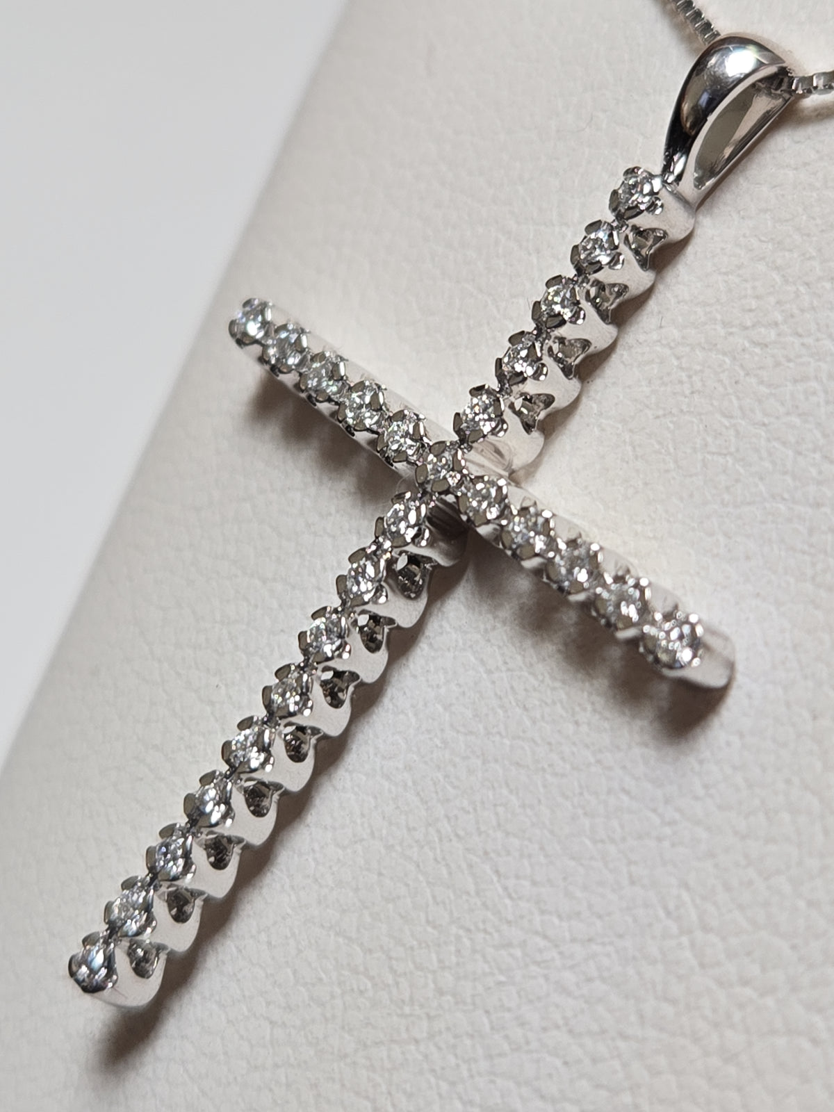 14K white gold cross pendant with 0.25ct lab-created diamonds, featuring a delicate design and weighing 1.6 grams.