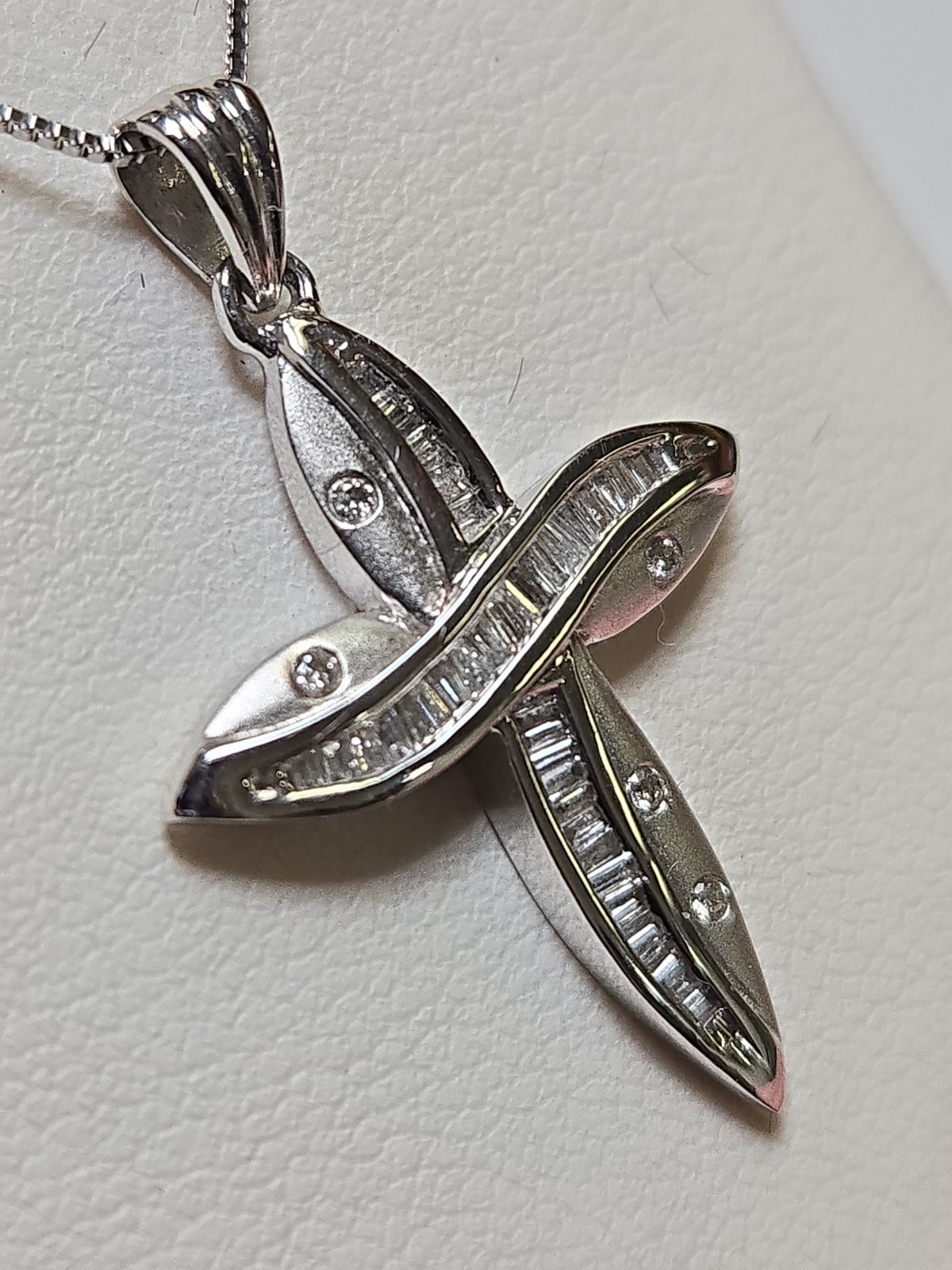 14K white gold cross pendant with 0.35ct baguette diamonds from Chique Jewelry, showcasing intricate design and sparkling stones.