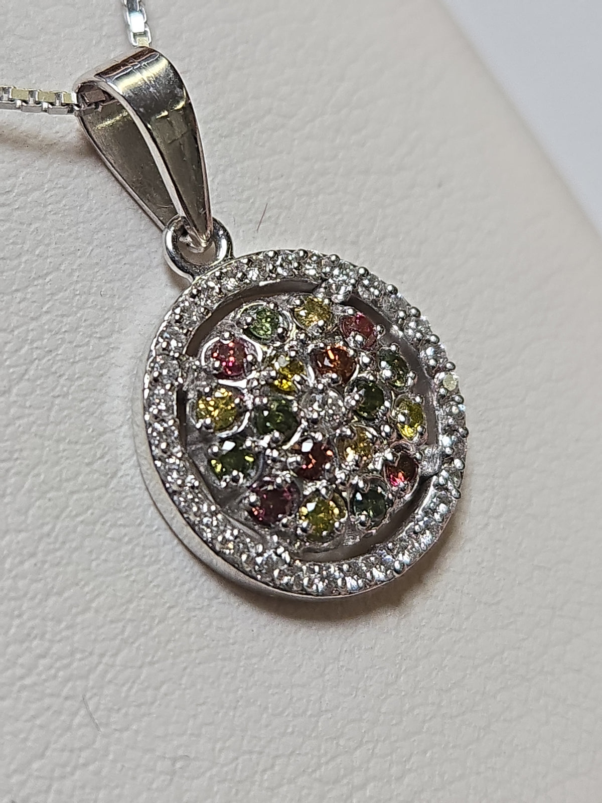 14K white gold pendant with 0.4ct round multicolor treated diamonds, weighing 2.5g, from Chique Jewelry.