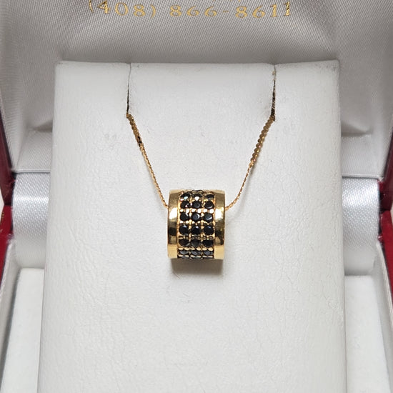 Bulgari 18K gold pendant with 0.5ct round black diamonds, elegant jewelry piece showing the pendant's detailed design.