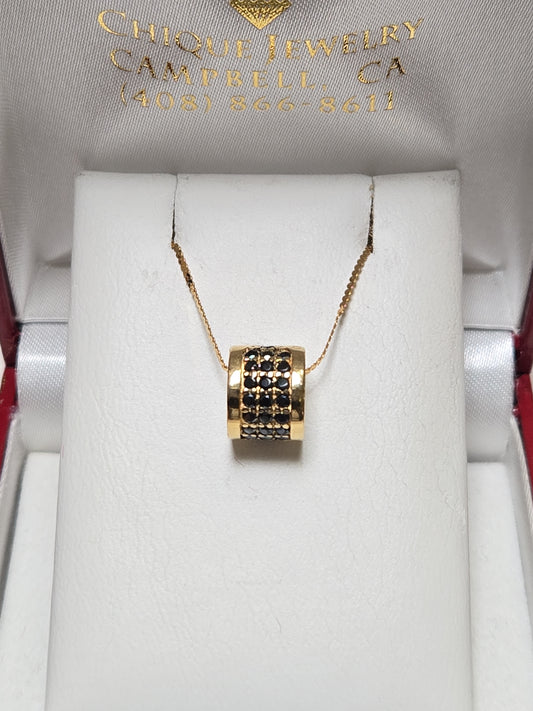 Bulgari 18K gold pendant with 0.5ct round black diamonds, elegant jewelry piece showing the pendant's detailed design.