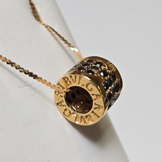 Bulgari 18K gold pendant with 0.5ct round black diamonds, elegant jewelry piece, weighing 3.4 grams.