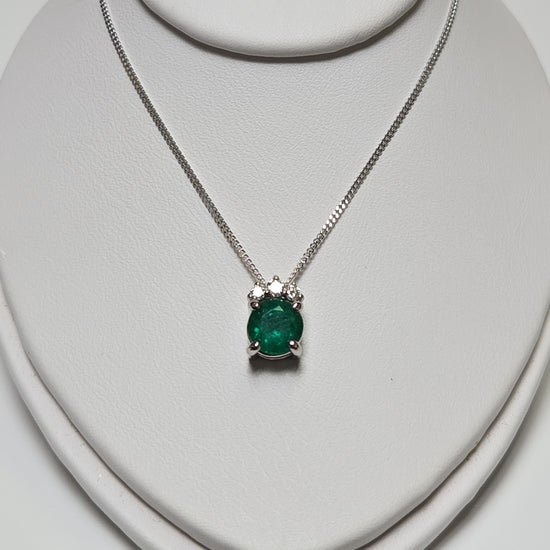14K white gold pendant necklace featuring a 0.83ct oval emerald gemstone, crafted by Chique Jewelry.