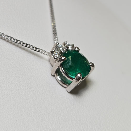 14K white gold pendant necklace with a 0.83ct oval emerald, featuring a elegant jewelry design by Chique Jewelry.