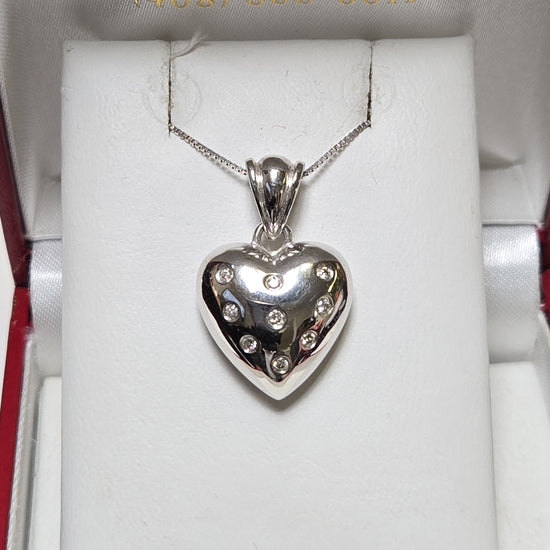 14K white gold heart pendant with 0.14ct round diamonds from Chique Jewelry, showcasing a delicate, elegant jewelry piece.