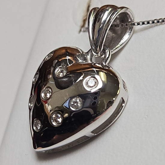 14K white gold heart pendant with 0.14ct round diamonds, elegant jewelry piece by Chique Jewelry, weighs 3 grams.