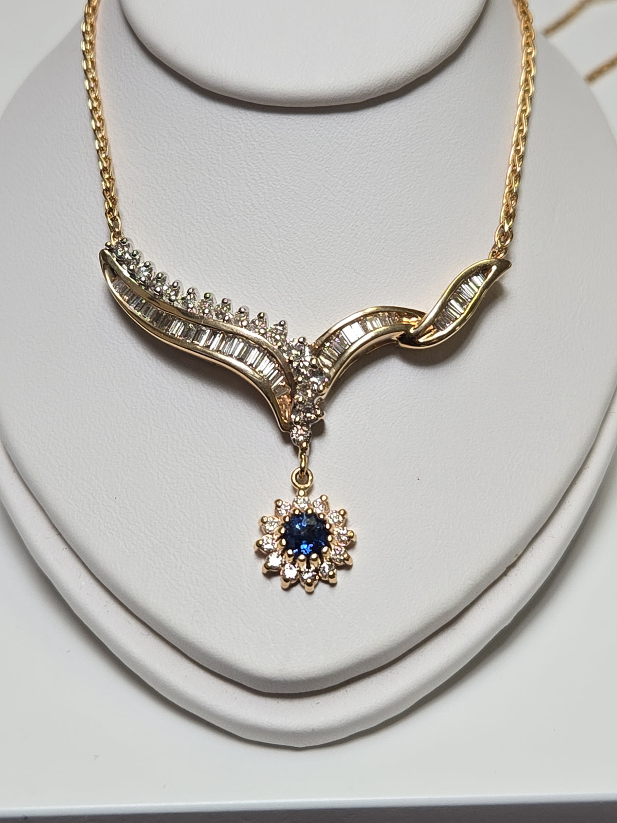 14K gold Spiga chain necklace with 0.2ct round blue sapphire pendant, 16-inch length, by Chique Jewelry.