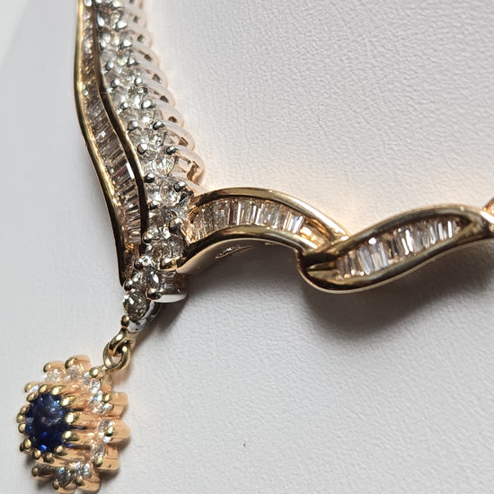 14K gold Spiga chain necklace with a 0.2ct round blue sapphire pendant, 16-inch length, by Chique Jewelry.