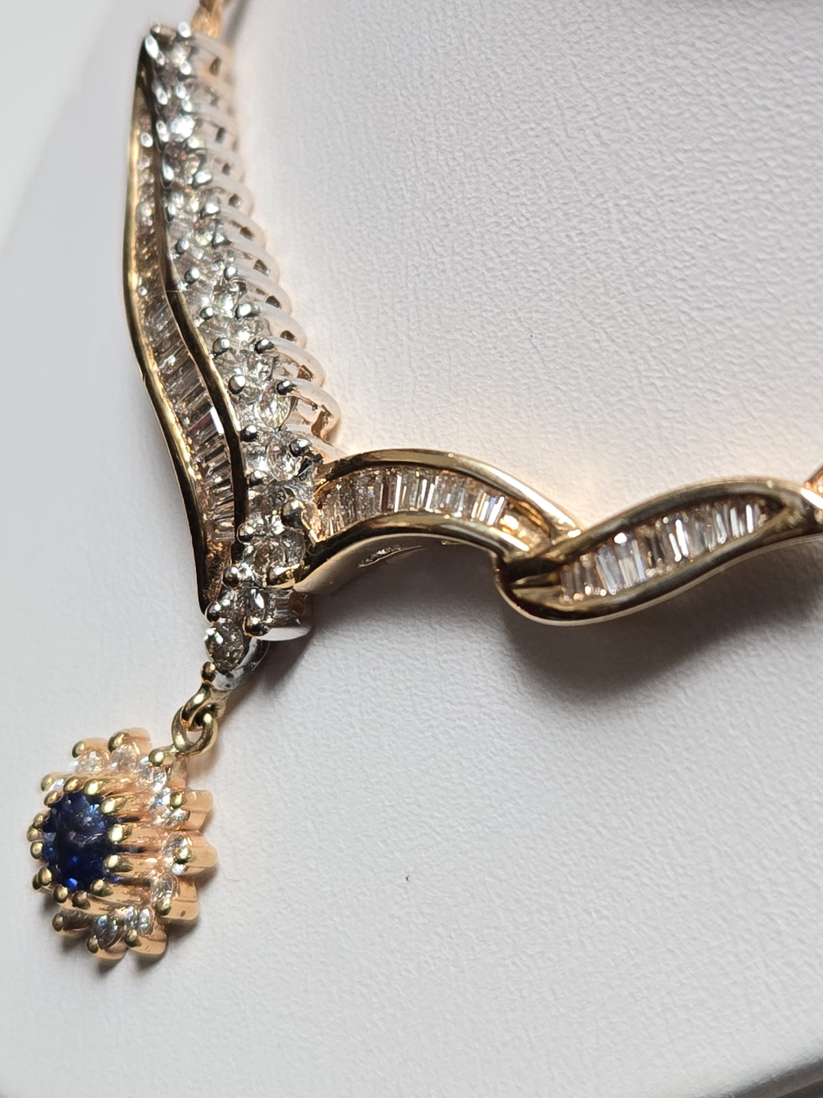 14K gold Spiga chain necklace with a 0.2ct round blue sapphire pendant, 16-inch length, by Chique Jewelry.
