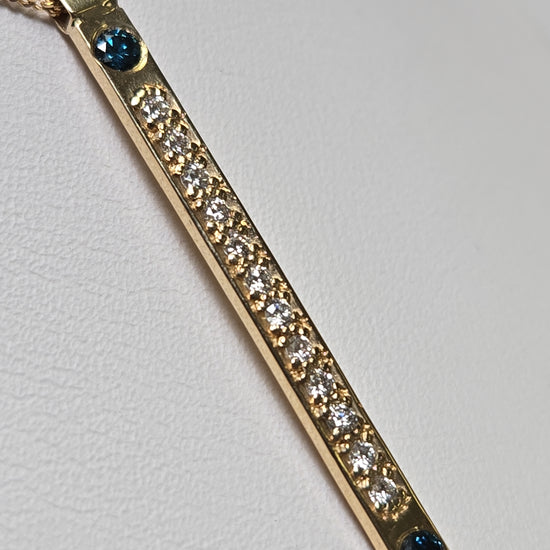 14K gold diamond cut curb chain necklace with blue treated diamonds, featuring a pendant, weighs 1.9 grams.