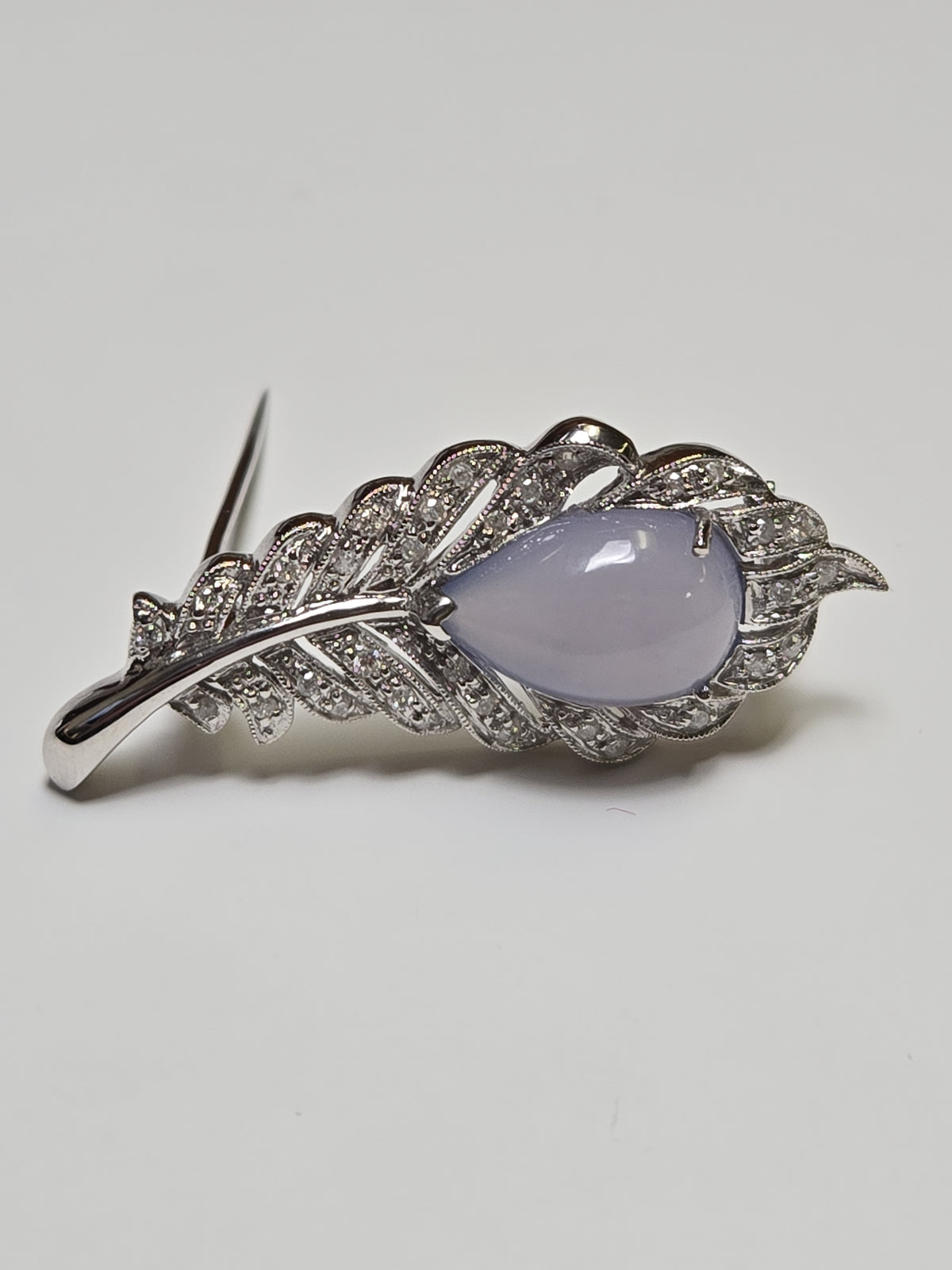 Pear-shaped lavender jade brooch in 14K white gold, designed by Chique Jewelry, weighing 6.7 grams.