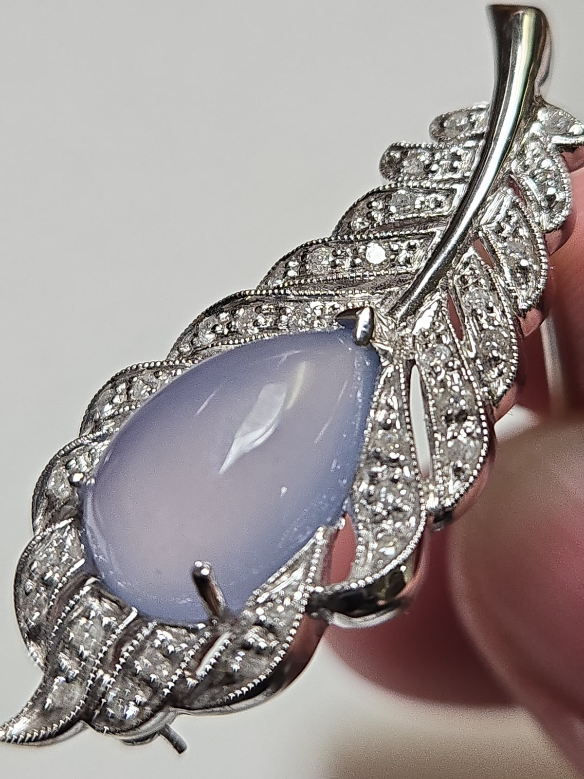 Pear-shaped lavender jade brooch in 14K white gold from Chique Jewelry, featuring elegant design and intricate craftsmanship.
