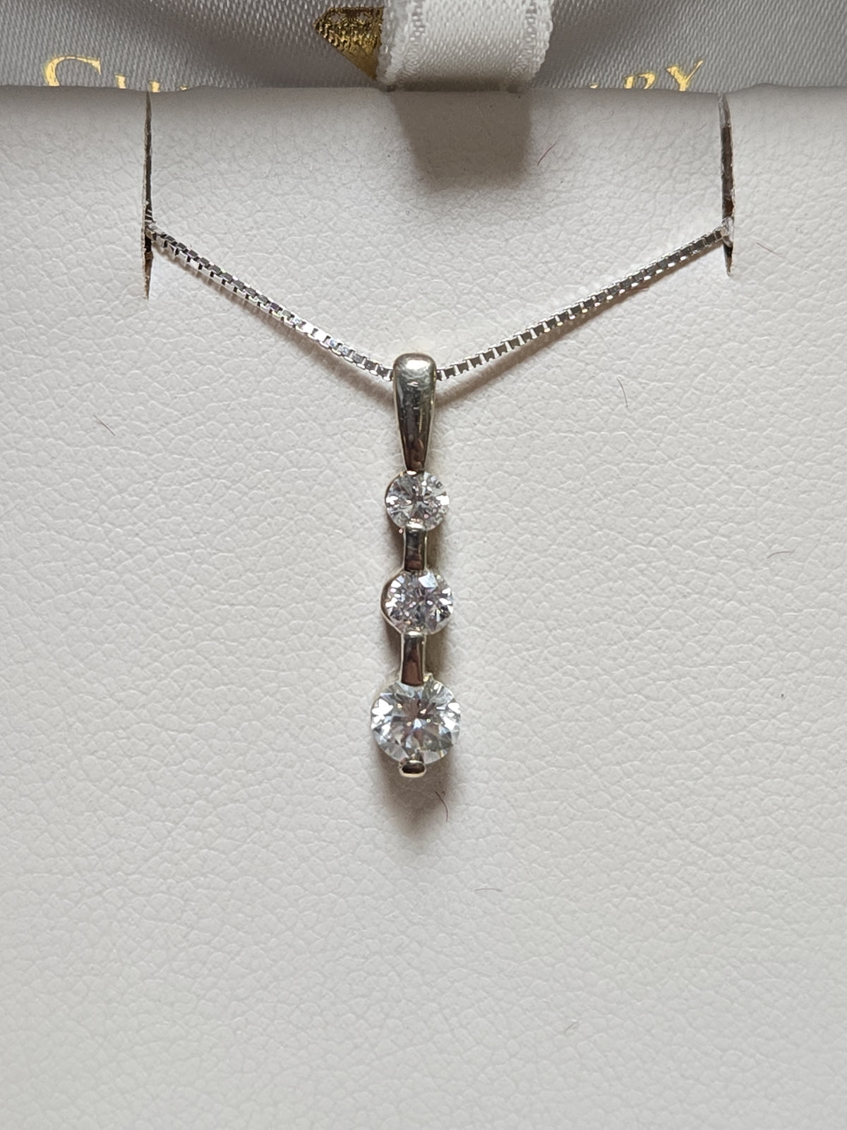 14K gold pendant with 0.3ct round diamonds from Chique Jewelry, showcasing the elegant jewelry piece with sparkling stones.
