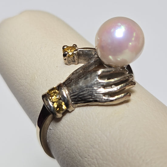 14K multi-tone gold ring with round pearl, elegant jewelry piece showcasing a polished band and a single pearl accent.