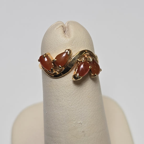 14K gold ring featuring a pear-shaped jade gemstone, weighing 1.6 grams, from Chique Jewelry.
