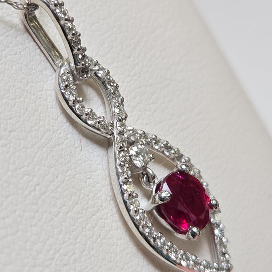 14K white gold pendant featuring a 1.15ct oval ruby, elegant jewelry piece with a 2g weight from Chique Jewelry.