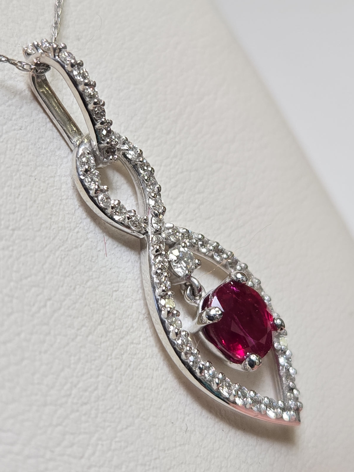 14K white gold pendant featuring a 1.15ct oval ruby, elegant jewelry piece with a 2g weight from Chique Jewelry.