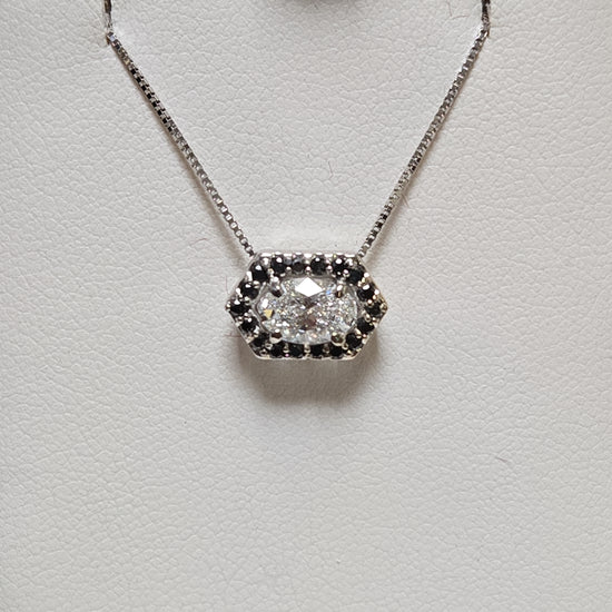 14K white gold pendant with 0.72ct oval lab-created diamond, showcasing elegant jewelry design and craftsmanship.
