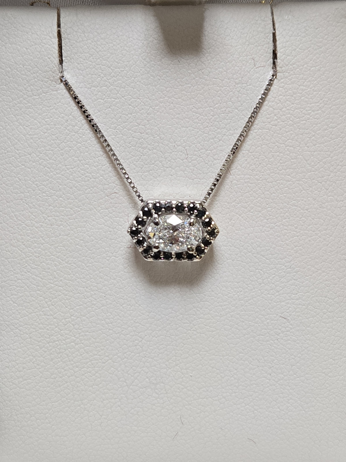 14K white gold pendant with 0.72ct oval lab-created diamond, showcasing elegant jewelry design and craftsmanship.
