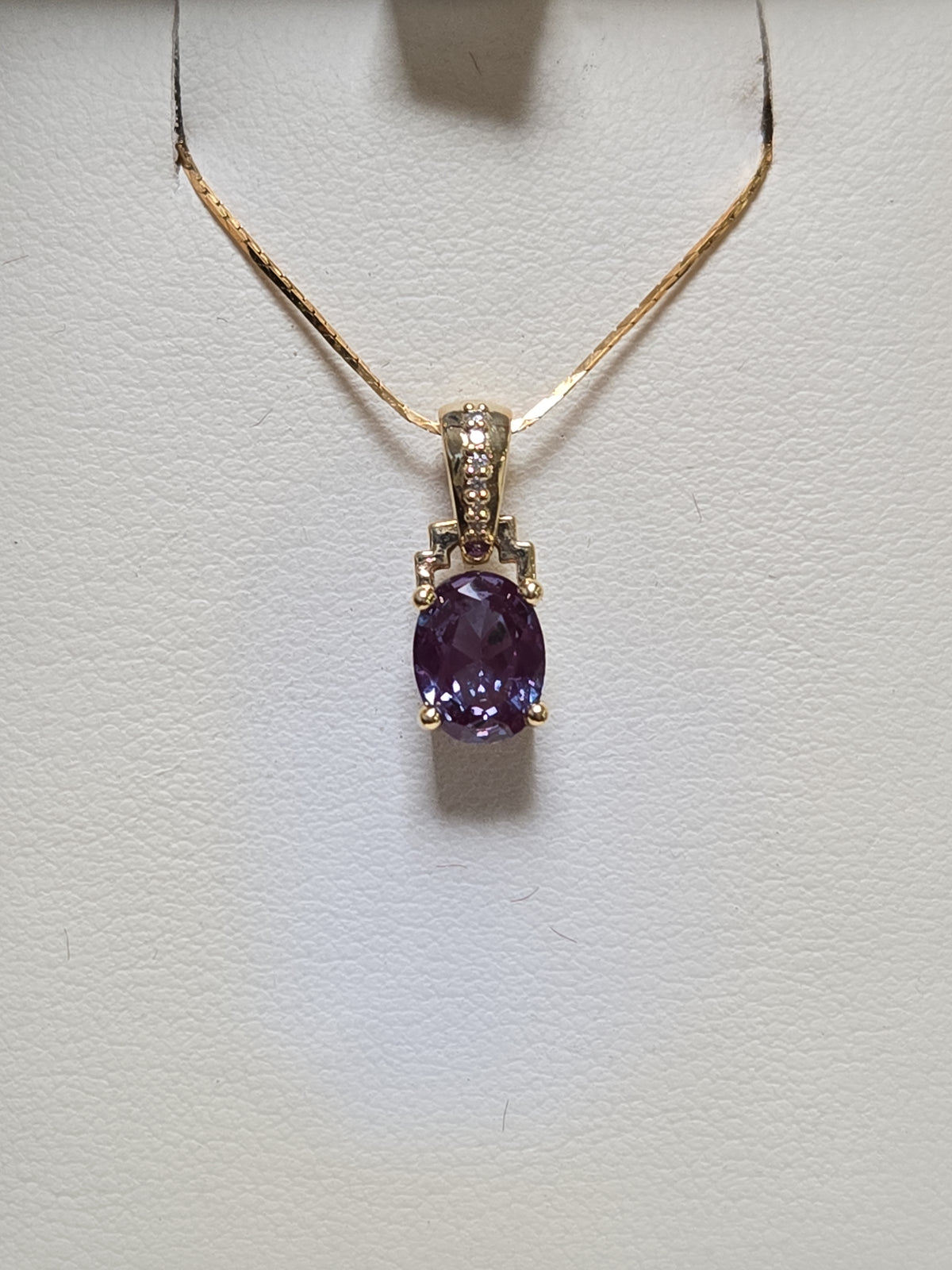 14K gold pendant featuring a 1.35ct oval lab-created alexandrite gemstone, crafted by Chique Jewelry.