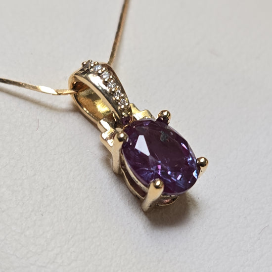 14K gold pendant with 1.35ct oval lab-created alexandrite gemstone, featuring elegant jewelry design.