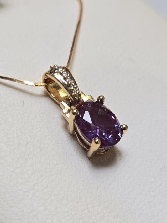 14K gold pendant with 1.35ct oval lab-created alexandrite gemstone, featuring elegant jewelry design.