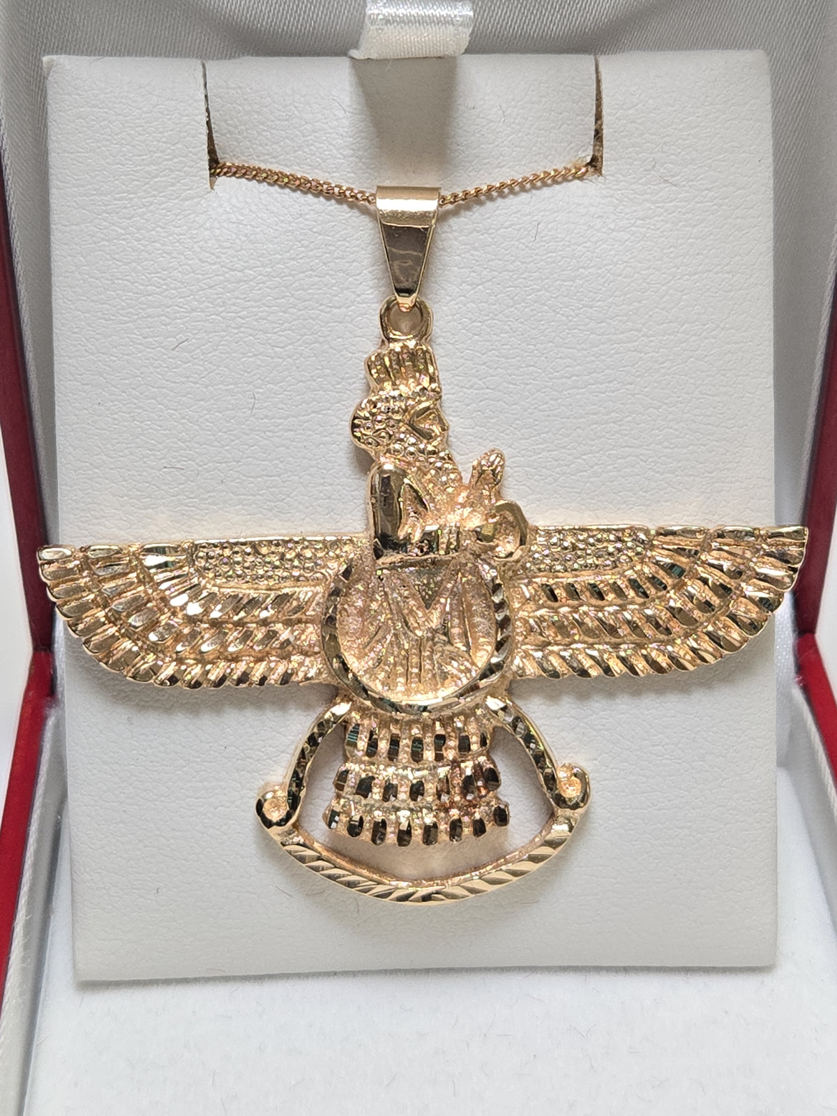 18K gold Farvahar pendant from Chique Jewelry, showcasing intricate design and craftsmanship in a detailed jewelry image.