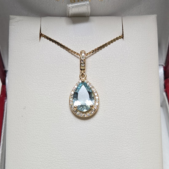 14K gold pendant featuring a 1.5ct pear-shaped aquamarine gemstone, with a delicate chain and elegant design.