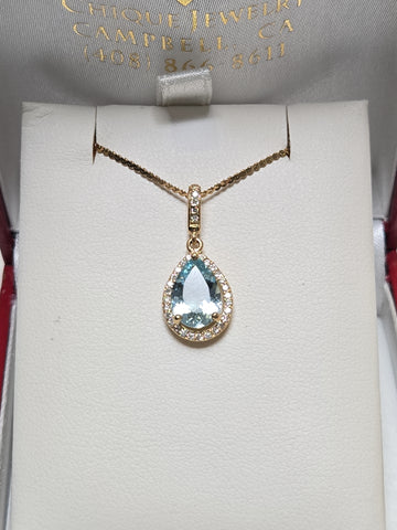 14K gold pendant featuring a 1.5ct pear-shaped aquamarine gemstone, with a delicate chain and elegant design.