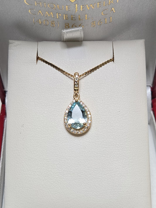 14K gold pendant featuring a 1.5ct pear-shaped aquamarine gemstone, with a delicate chain and elegant design.
