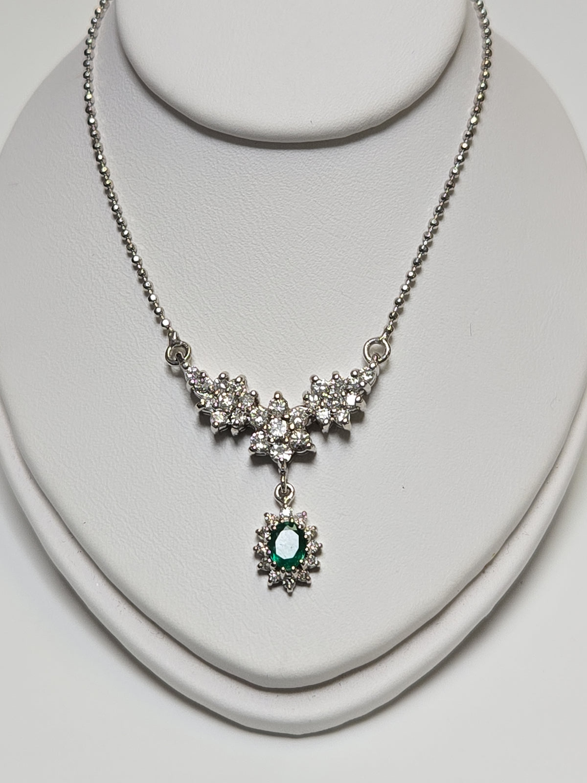 14K white gold bead chain necklace with 0.35ct oval emerald pendant, 16-inch length, from Chique Jewelry.