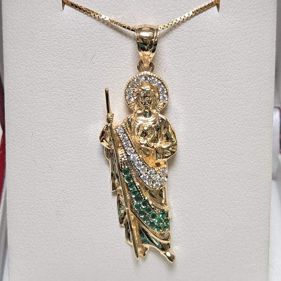 14K gold Jesus pendant with round cubic zirconia, showcasing detailed religious jewelry from Chique Jewelry.