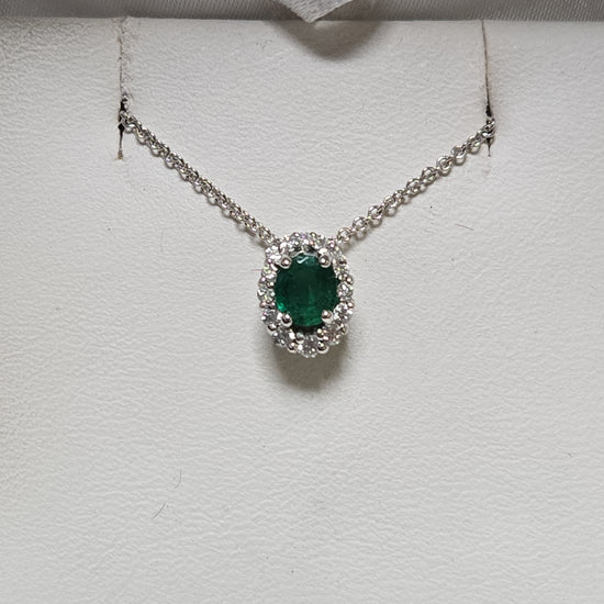 14K white gold pendant with a 0.4ct oval emerald gemstone, weighing 0.8 grams, by Chique Jewelry.