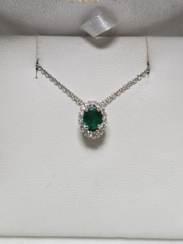 14K white gold pendant with a 0.4ct oval emerald gemstone, weighing 0.8 grams, by Chique Jewelry.