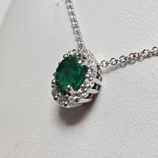 14K white gold pendant featuring a 0.4ct oval emerald, crafted by Chique Jewelry, with delicate detailing and elegant design.