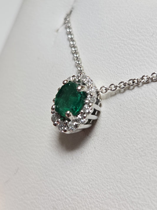 14K white gold pendant featuring a 0.4ct oval emerald, crafted by Chique Jewelry, with delicate detailing and elegant design.