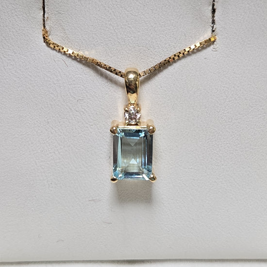 14K gold pendant featuring a large emerald-cut aquamarine gemstone, weighing 1.7 grams, from Chique Jewelry.