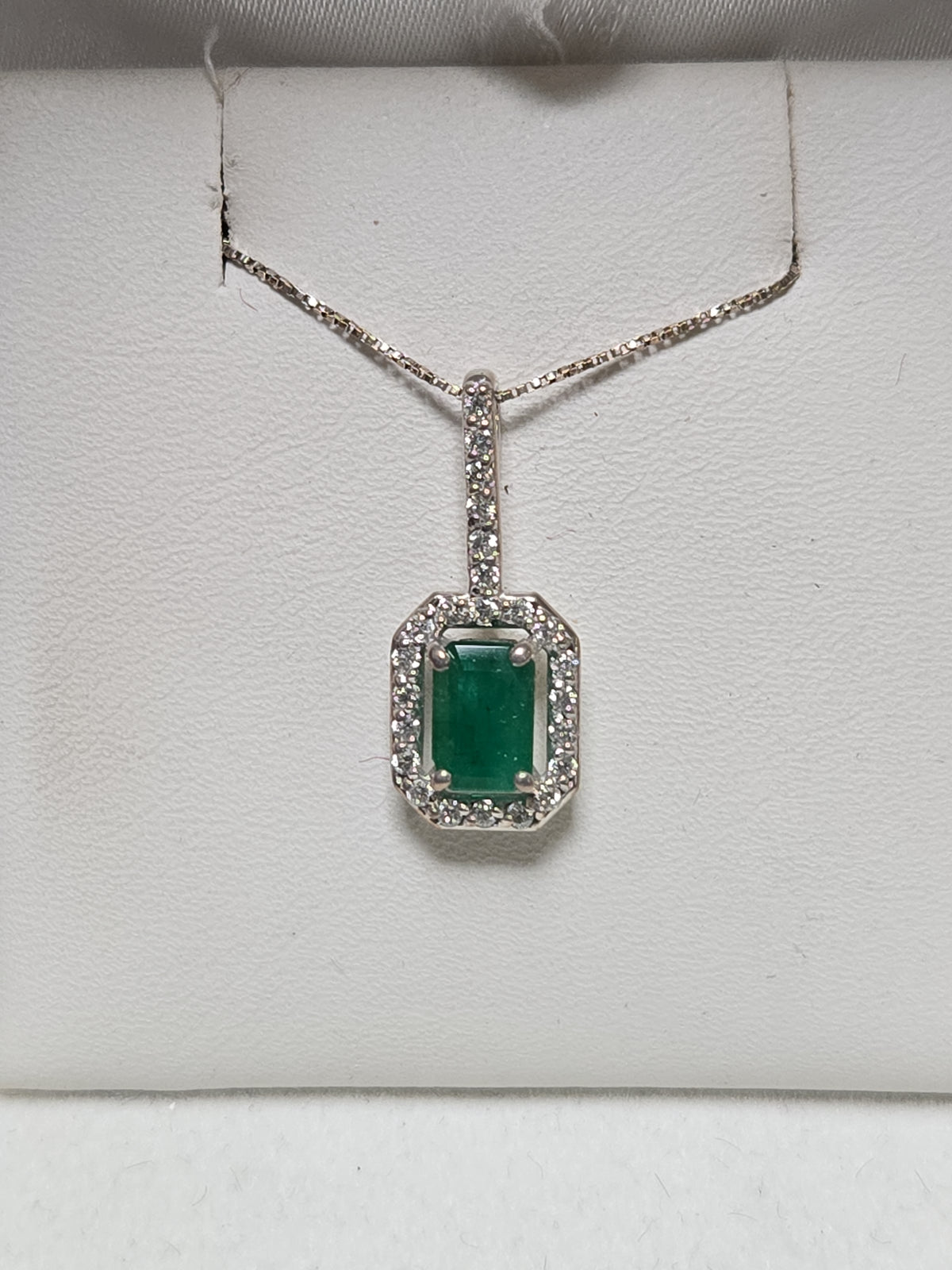 14K white gold pendant featuring a 0.75ct emerald-cut emerald gemstone, weighing 1.1 grams, by Chique Jewelry.