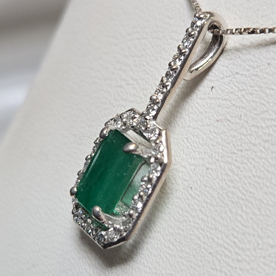 14K white gold pendant featuring a 0.75ct emerald-cut emerald, weighing 1.1g, from Chique Jewelry.